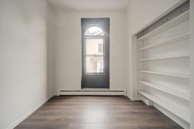 spare room featuring dark hardwood / wood-style flooring and a baseboard radiator