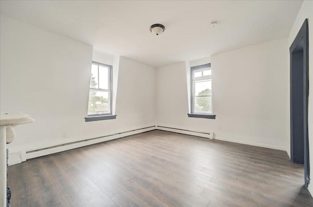 spare room with dark hardwood / wood-style flooring and a wealth of natural light