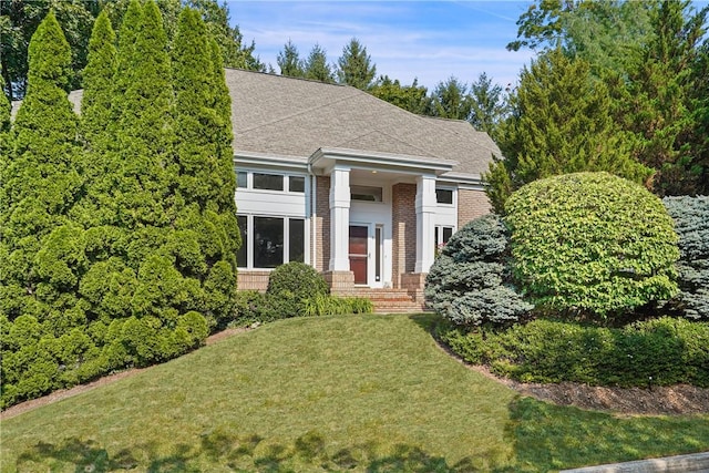 neoclassical home with a front lawn