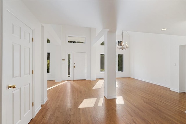 entryway with a chandelier and light wood-type flooring