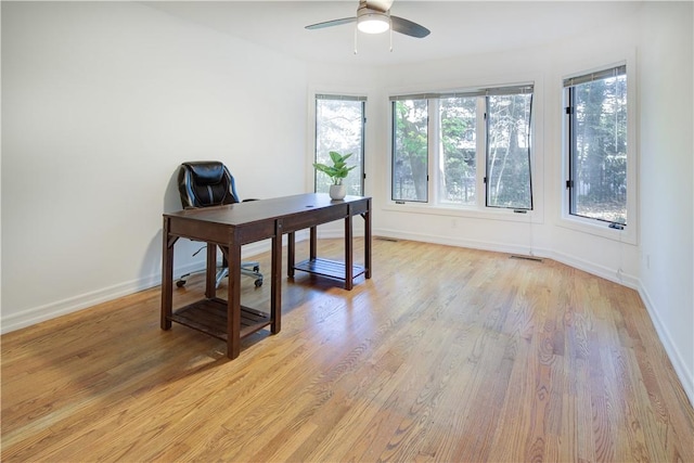 office area with light wood-type flooring and ceiling fan