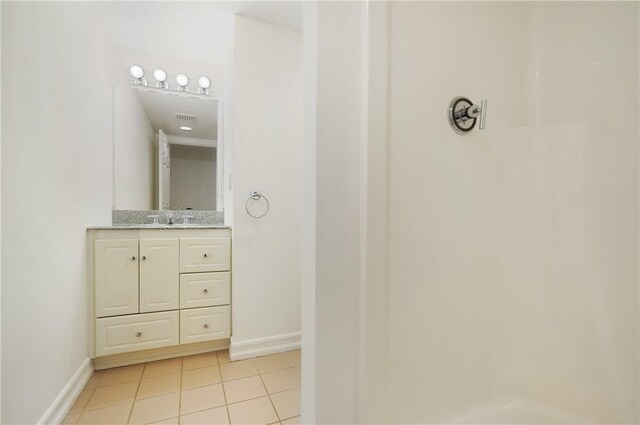 bathroom with tile patterned floors and vanity