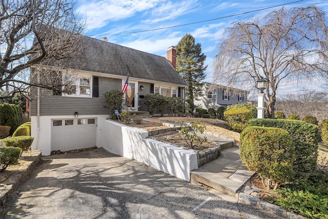 cape cod-style house with a garage