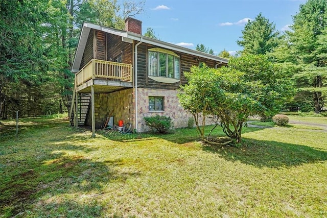 back of house with a lawn and a deck