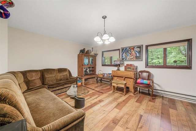 living room with baseboard heating, hardwood / wood-style floors, and a notable chandelier