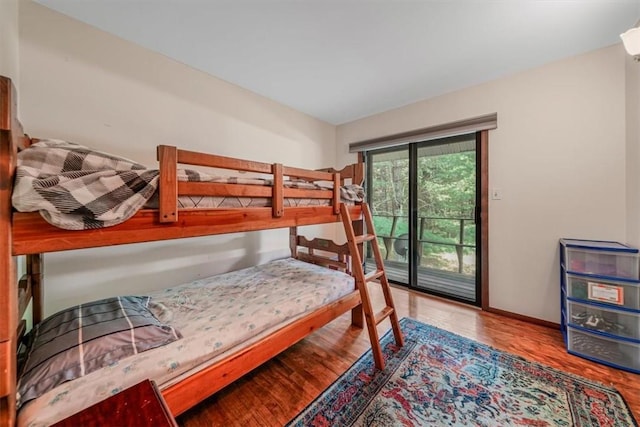 bedroom featuring access to exterior and hardwood / wood-style flooring