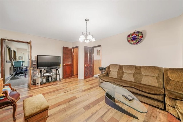 living room featuring a chandelier and hardwood / wood-style flooring