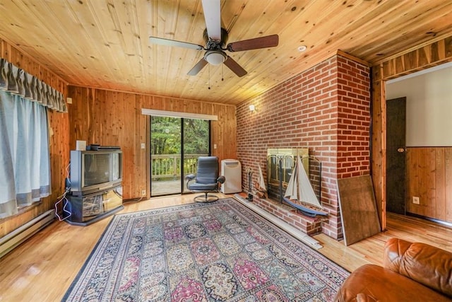 unfurnished room featuring ceiling fan, wooden ceiling, light wood-type flooring, and a baseboard heating unit