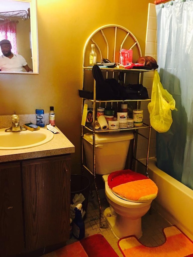 full bathroom with tile patterned flooring, vanity, shower / tub combo, and toilet