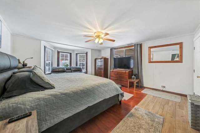 bedroom featuring hardwood / wood-style flooring, ceiling fan, and crown molding