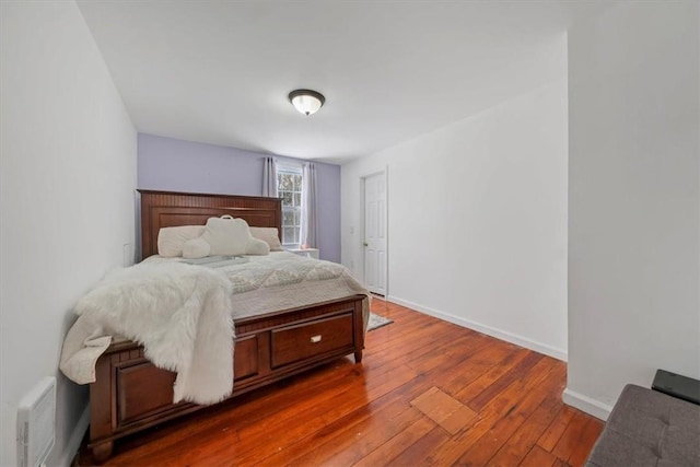 bedroom with dark hardwood / wood-style flooring