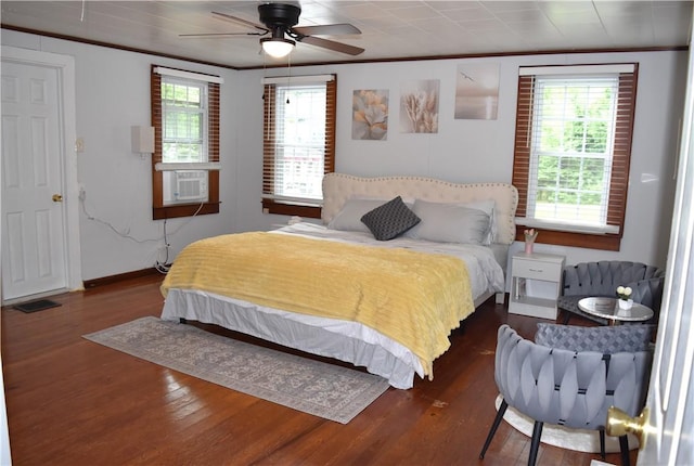 bedroom featuring multiple windows, ceiling fan, and dark wood-type flooring