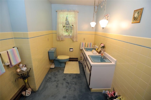 bathroom with vanity, toilet, tile walls, and a baseboard radiator