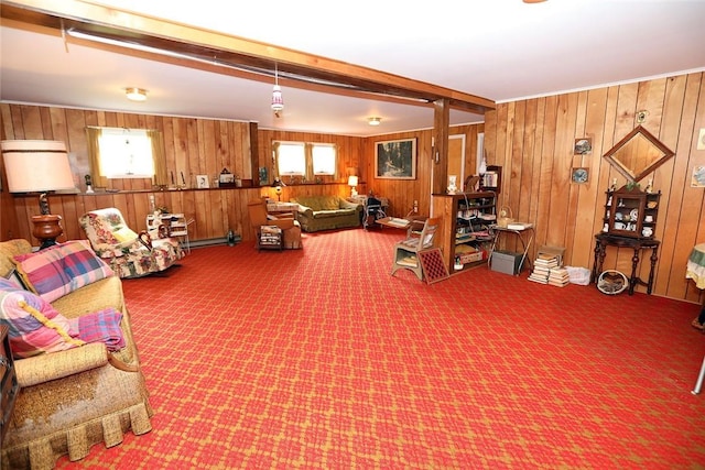 living room featuring beamed ceiling, wooden walls, and a healthy amount of sunlight