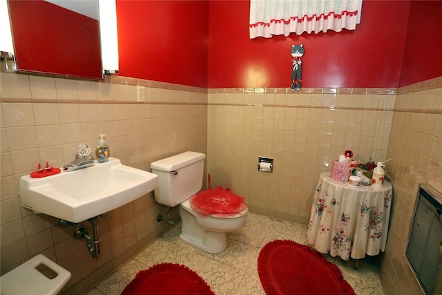 bathroom with tile walls