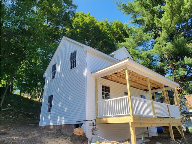 view of property exterior featuring a deck