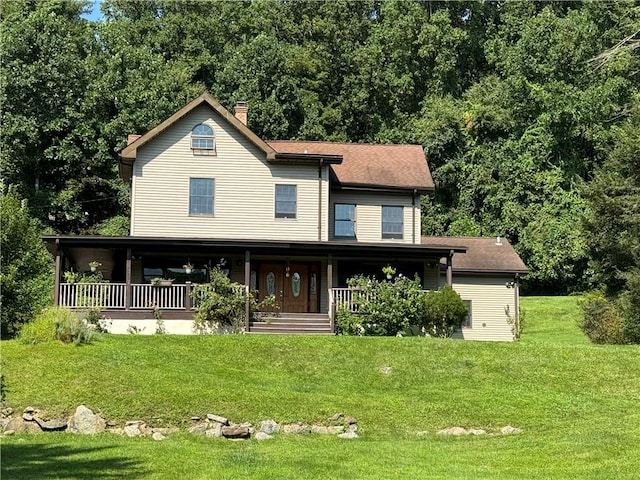 view of front of house with covered porch and a front yard