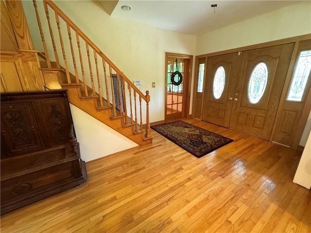 foyer with a wealth of natural light and light hardwood / wood-style flooring