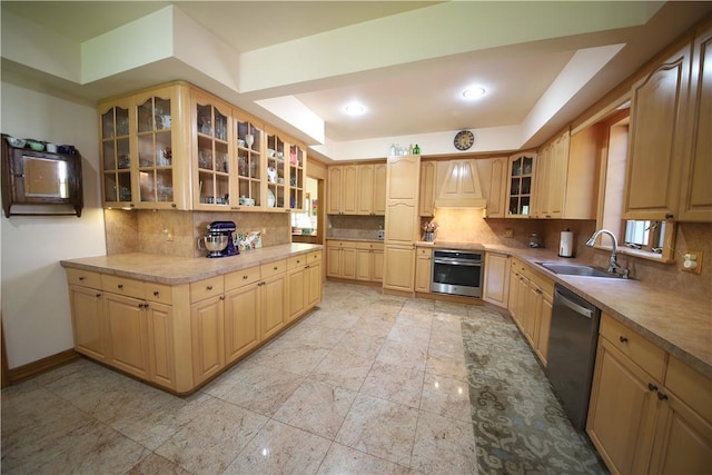 kitchen featuring appliances with stainless steel finishes, light brown cabinets, and sink