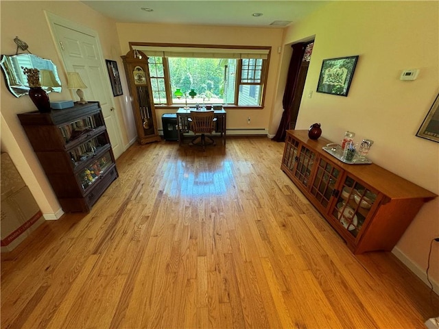 interior space featuring light hardwood / wood-style flooring and a baseboard heating unit