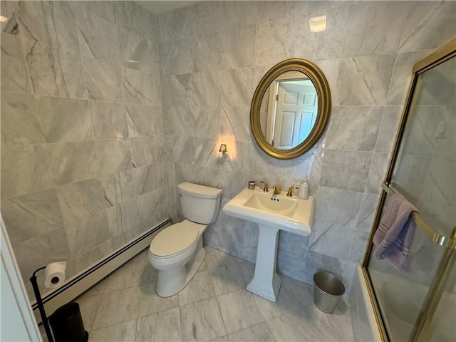 bathroom with toilet, bath / shower combo with glass door, tile walls, and baseboard heating