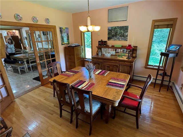 dining area featuring an inviting chandelier and light wood-type flooring