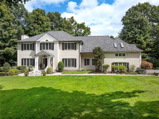 back of house featuring a lawn