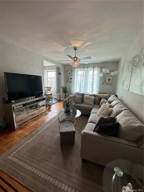 living room with parquet flooring and ceiling fan