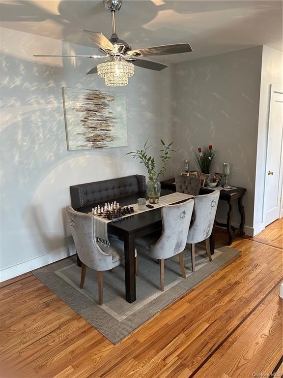 dining area featuring hardwood / wood-style flooring and ceiling fan