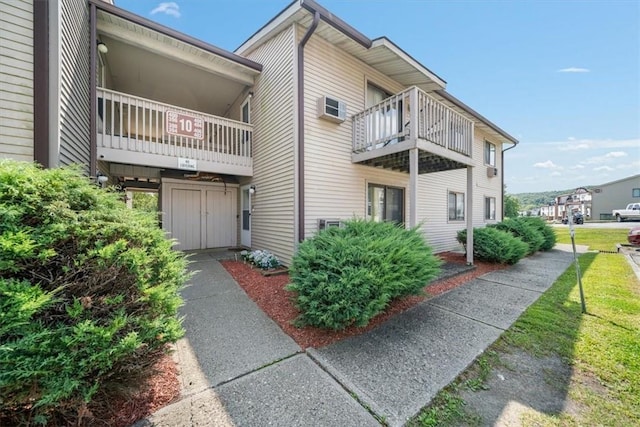 view of home's exterior with a wall unit AC