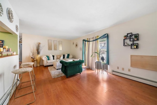 living room with baseboard heating and hardwood / wood-style flooring