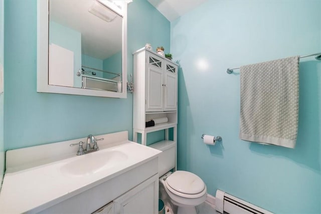 bathroom featuring baseboard heating, vanity, and toilet