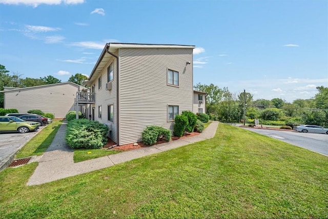 view of property exterior with a yard