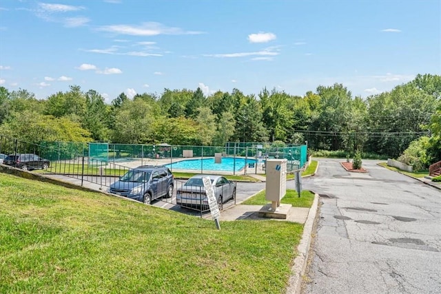 view of swimming pool featuring a lawn