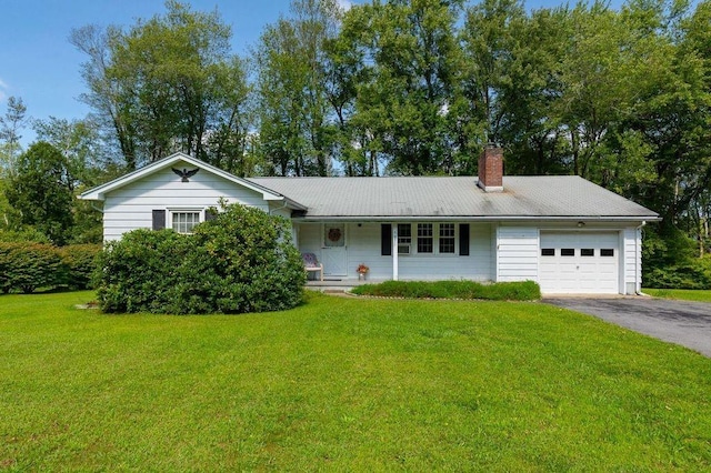 ranch-style home with a garage and a front lawn