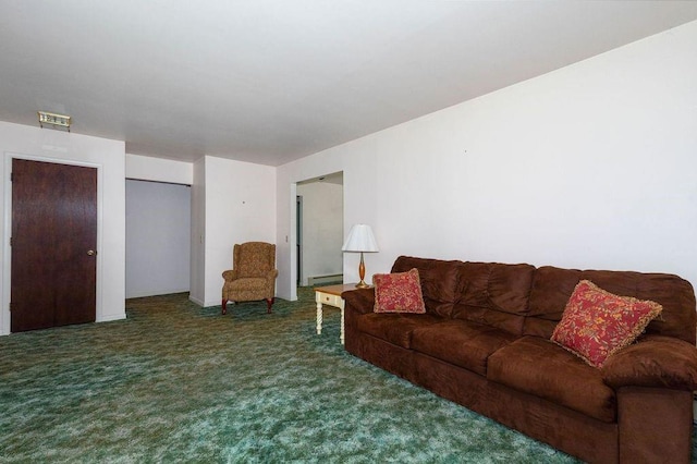 living room featuring a baseboard radiator and dark colored carpet