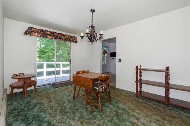 carpeted dining room featuring a chandelier