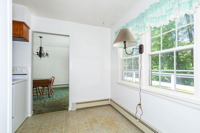 unfurnished dining area with a chandelier, light colored carpet, washer / clothes dryer, and a baseboard radiator