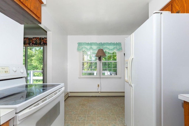 kitchen with a wealth of natural light, white appliances, and a baseboard heating unit