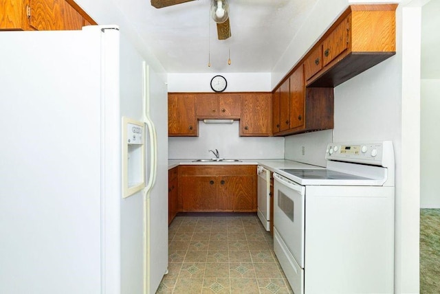 kitchen with white appliances, ceiling fan, and sink