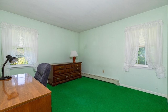 office area with dark colored carpet, a healthy amount of sunlight, and a baseboard heating unit