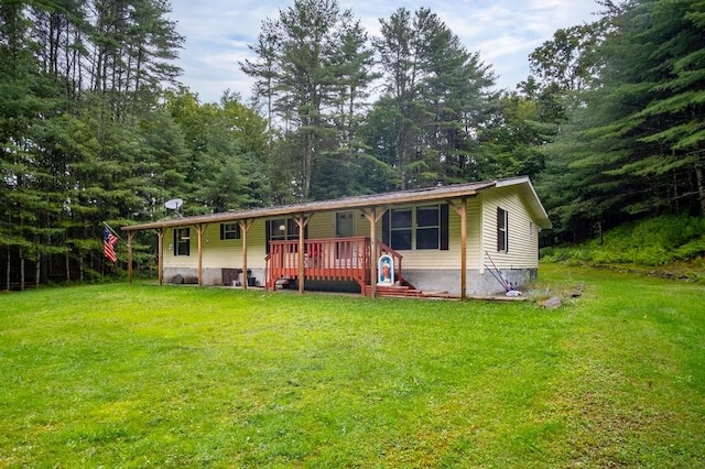 view of front of house with a wooden deck and a front lawn