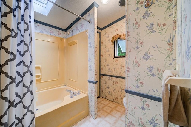 bathroom featuring shower with separate bathtub, a skylight, and a healthy amount of sunlight