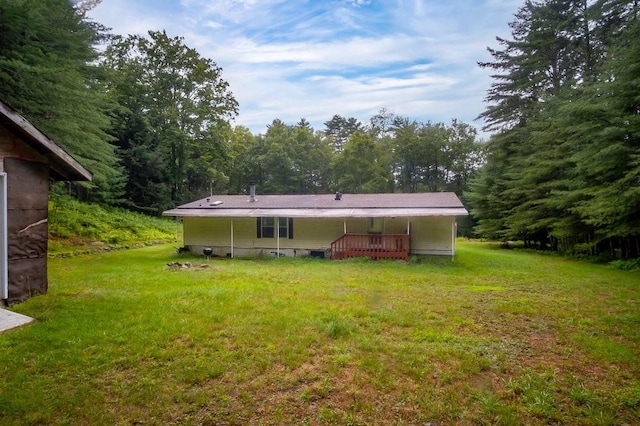 back of house with a lawn