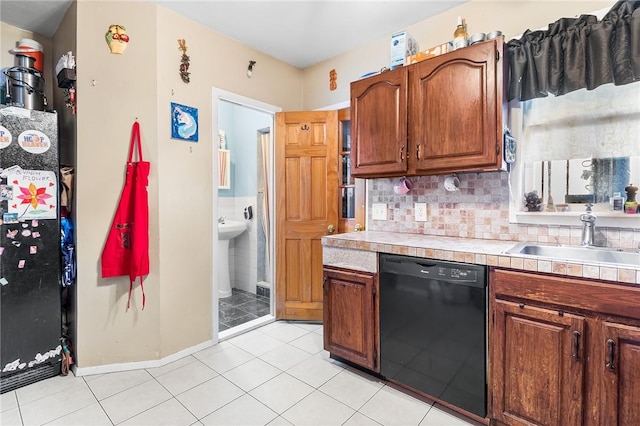 kitchen with backsplash, sink, black dishwasher, tile counters, and light tile patterned flooring