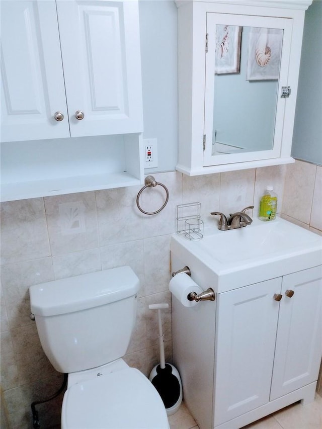 bathroom featuring vanity, tasteful backsplash, toilet, and tile walls