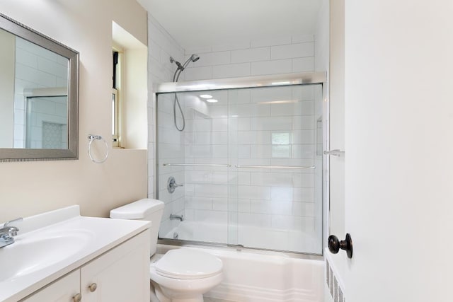 full bathroom featuring vanity, toilet, and enclosed tub / shower combo