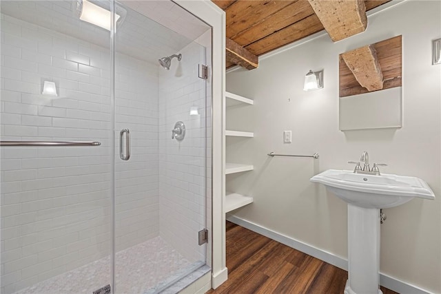 bathroom with sink, hardwood / wood-style flooring, walk in shower, and wood ceiling