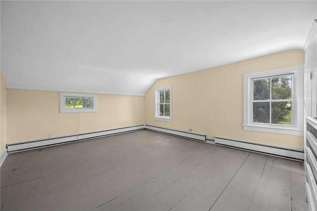 additional living space with lofted ceiling, a baseboard radiator, light hardwood / wood-style flooring, and a healthy amount of sunlight