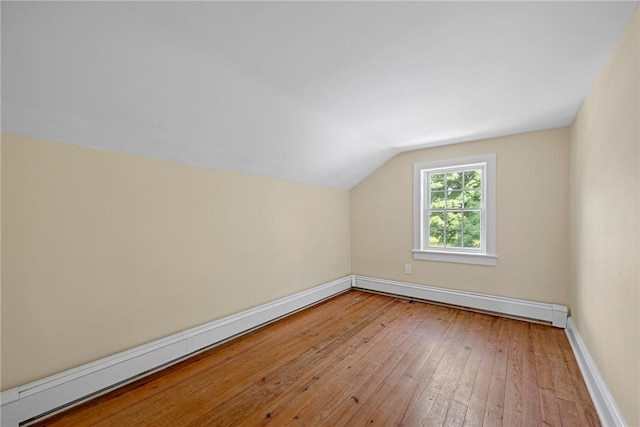 bonus room featuring light hardwood / wood-style floors, lofted ceiling, and baseboard heating